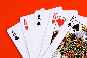 A full house poker game on red background.