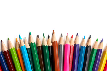 Assortment of coloured pencils with shadow on white background