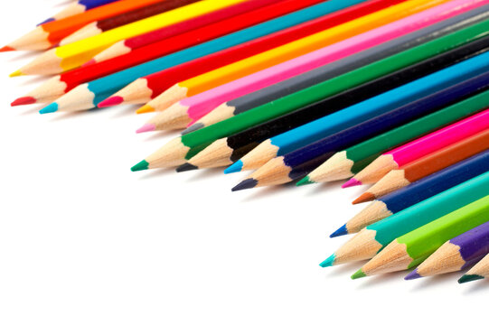 Assortment of coloured pencils with shadow on white background