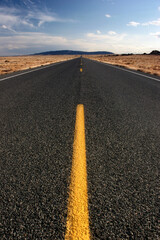 long straight highway in wyoming, vertical wide angle