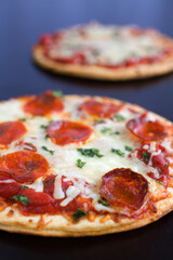 Two Pepperoni Pizzas on a Table