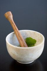 Muddling Mint in a marble morter