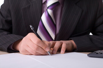 Businessman at the desk with signing agreement.
