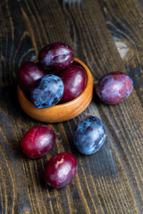 Ripe plums on the table in the kitchen