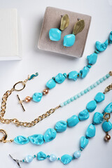 author collection jewelry with azure gemstones, pearls and chain demonstrated at white background. ...
