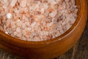 Pink natural salt on the table, close up