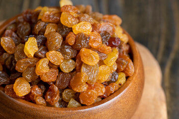 Dried yellow golden raisins on a board