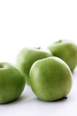Fresh green apples on a white background.