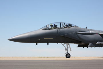 Fototapeta na wymiar F-15 Strike Eagle taxiing to runway, closeup of cockpit with pilot and acknowledgement from the weapons systems officer