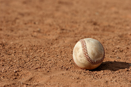 macro of a baseball lost on the field