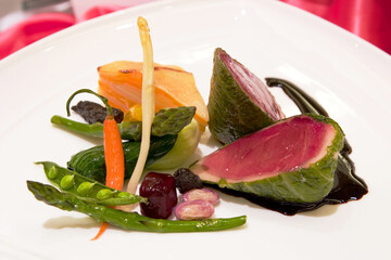 Veal tenderloin wrapped with savoy cabbage and complimented with a medley of vegetables and...