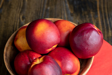 Nectarines folded in a wooden bowl