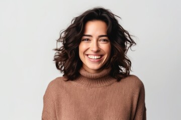 Fototapeta premium Portrait of a smiling young woman in sweater looking at camera isolated over white background