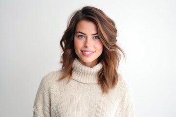 Portrait of beautiful young woman in sweater on a white background.