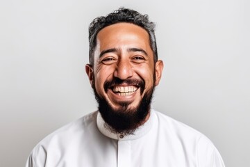 Fototapeta premium Portrait of a happy middle-eastern man with a beard on a white background