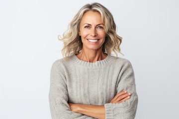 Portrait of a happy mature woman with arms crossed isolated on a white background