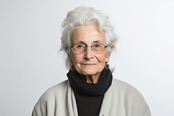 Portrait of a senior woman with grey hair wearing glasses and scarf