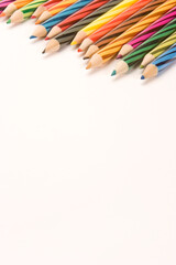 Coloured Pencils set against a Plain Background.