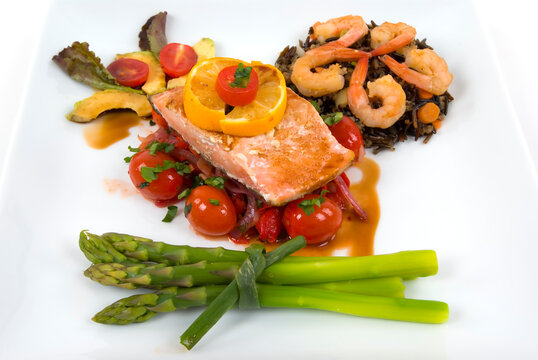 Salmon,asparagus, wild rice with shrimp, onion,roasted peppers and tomatoes with pomegranate sauce