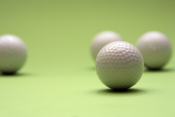 A few golfballs with green background