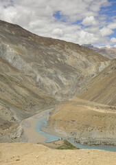Sangam of the Zanskar and Indus rivers flowing through dry mountains in Nimmu Valley, Ladakh, INDIA. 