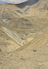 A view of confluence of the Zanskar and Indus rivers flowing through beautiful dry mountains in...