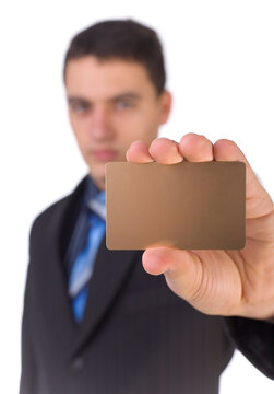 Young man showing gold card; White background in studio. Focus on the card. Body unfocus.