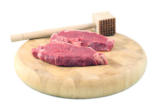 Tenderized Steak on a chopping board on a white background