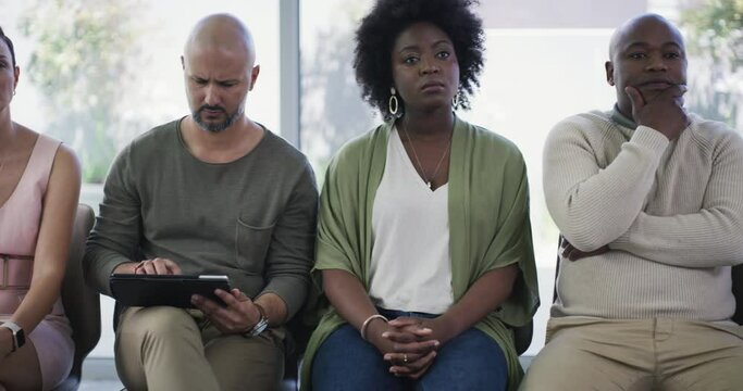 Business people, waiting room and row in meeting, seminar or listening in workshop presentation at office. Group of employees sitting in line during training, interview or recruiting at the workplace