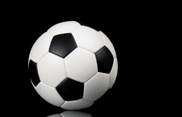 Fototapeta na wymiar football - soccer ball on black background with reflection