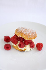 Butter Milk Biscut overflowing with fresh raspberries and cream