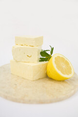 Fresh Feta Cheese Drizzled with Honey and Lemon on a marble cuting board. A healthy Cheese Plate, A great start to any salad.