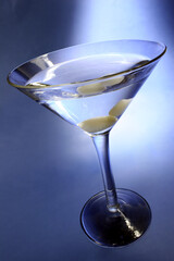 Martini in shaft of light with blue background
