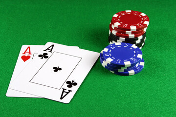 Playing cards showing a pair of aces with poker chips next to them