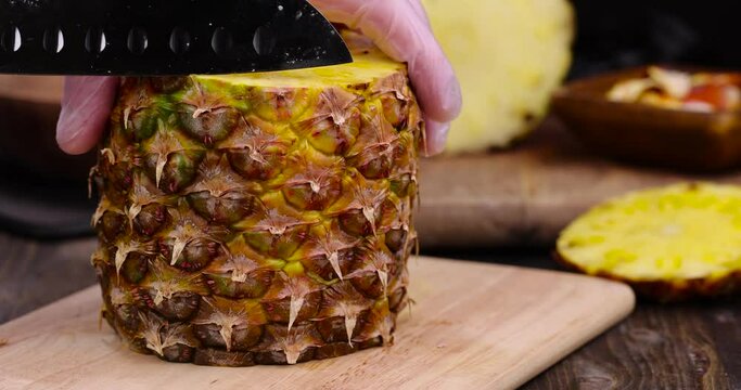 cut a delicious ripe pineapple yellow, pieces of sweet and juicy pineapple cut on a cutting board