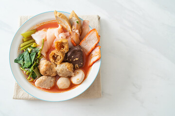 noodles with meatballs in pink soup