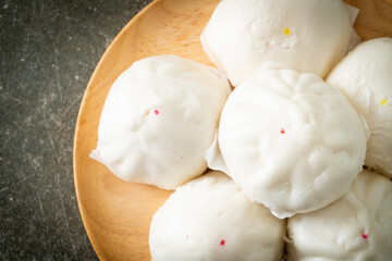 stuffed steamed bun on wood plate