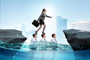 Inequal competition concept with businesswoman walking on heads