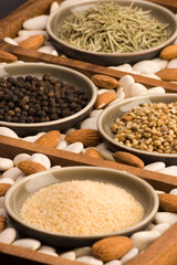 Various Spices close up in a wooden tray.