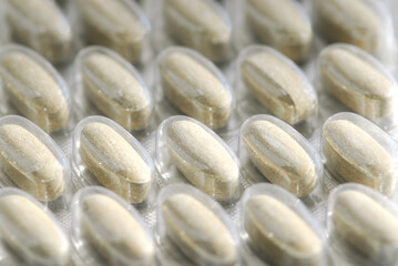 Background of herbal supplement pills close up