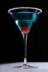 blue cocktail with red glace cherries