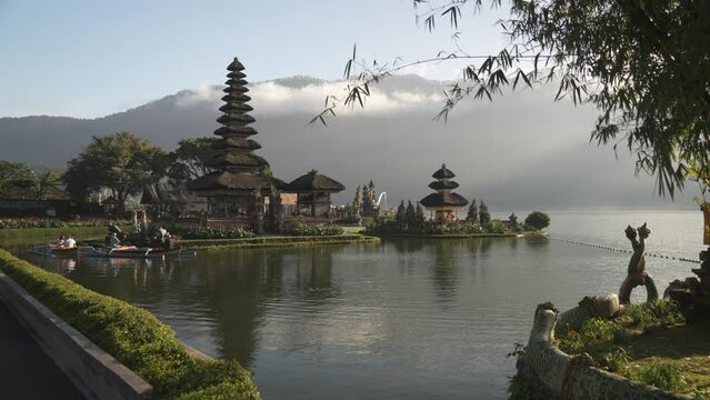 Canang sari, offering to the Gods at Ulun Danu Beratan Temple and lake Danu Beratan Bedugul at sunrise, Bali, Indonesia, South East Asia