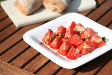 tomatoes with basil on white plate