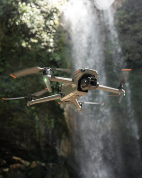 DJI Mavic 3 drone with Hasselblad camera hovers in front of waterfall on sunny day. Photo taken in Costa Rica on March 22, 2023.
