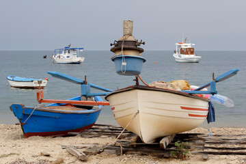 greek fishing boats anchored off the beach