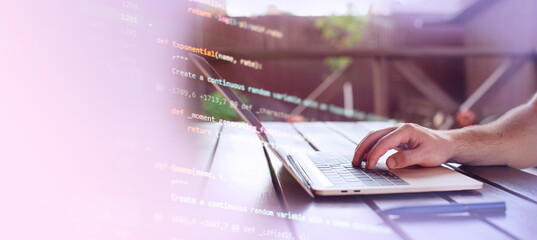 Man working on laptop in garden. Closeup of male hands typing on computer keyboard.