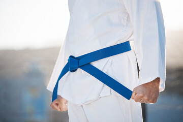 Karate, fitness and discipline with a sports man in gi, training in the city on a blurred...