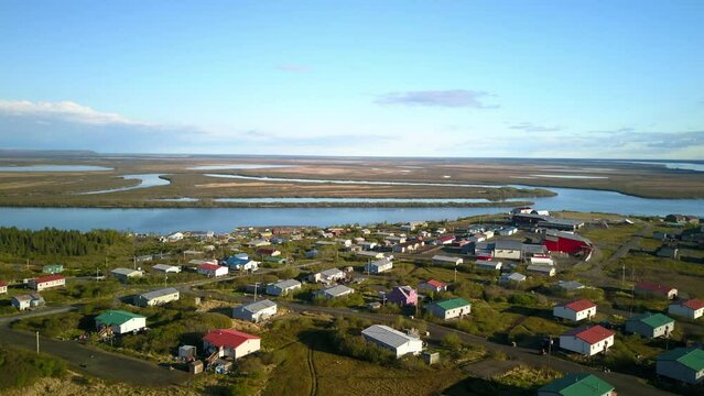 Timelapse Aerial Lockdown Of A Small Coastal Town At Sunrise With Surrounding Wetlands - Bering Sea, Alaska