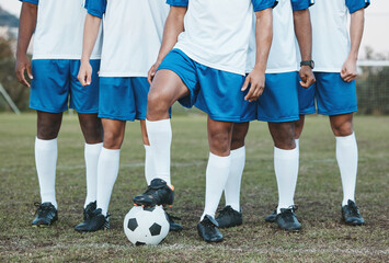 Soccer ball, sports group and feet of a team on a field to start fitness training or game outdoor. Football player, club and legs of athlete men together for sport competition, exercise and challenge