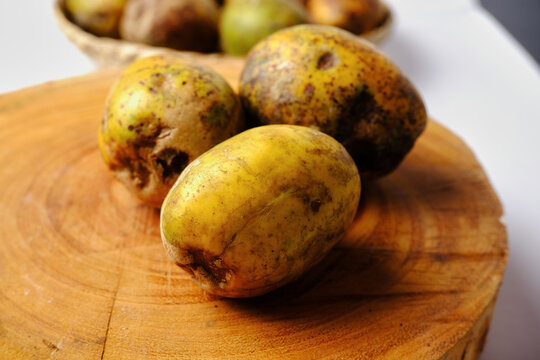 this is kedondong fruit or ambarella fruit on a wooden cutting board